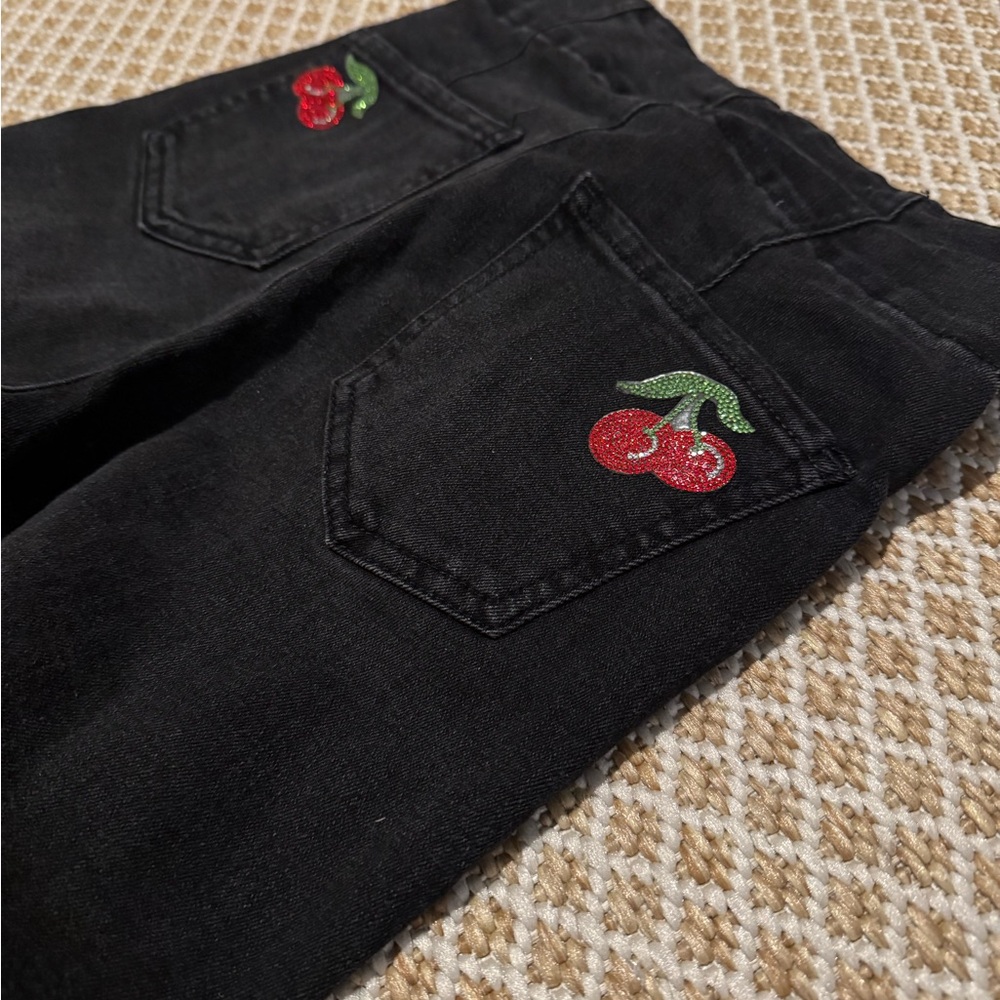 Black jeans with sequin cherry details